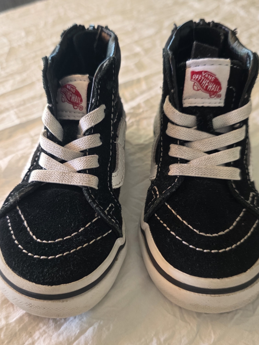 The VANS Sk8-Hi Black White Canvas High Top Sneakers in unisex kids size US 6